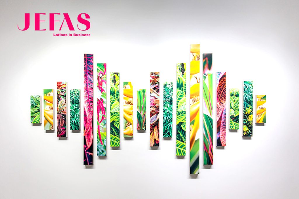 Colorful stips of photos line a white wall